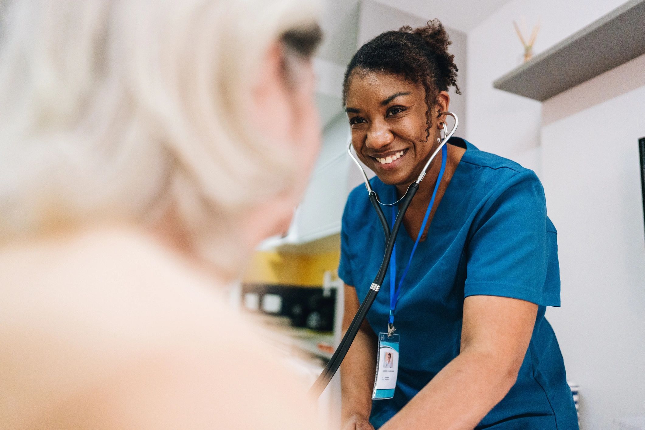 Nurse assisting a senior woman at home